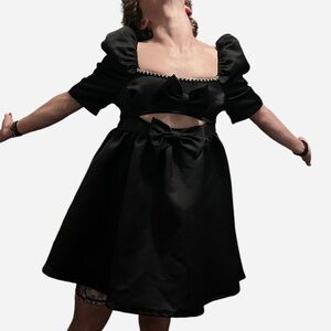 Black baby doll dress with two big bows, and a cut out in the middle. Size L
